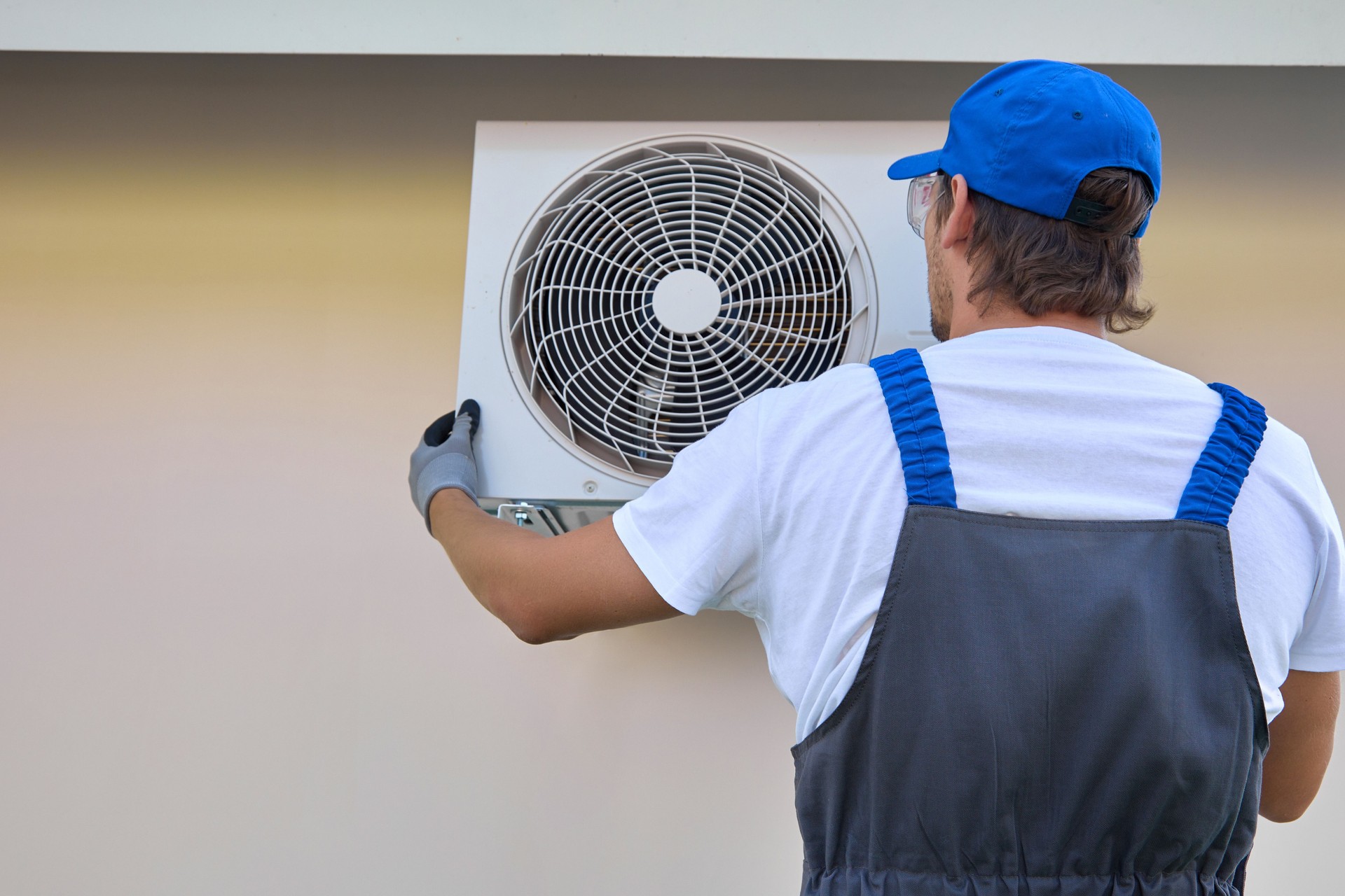 Experienced master installs modern air conditioner cool temperature inside room